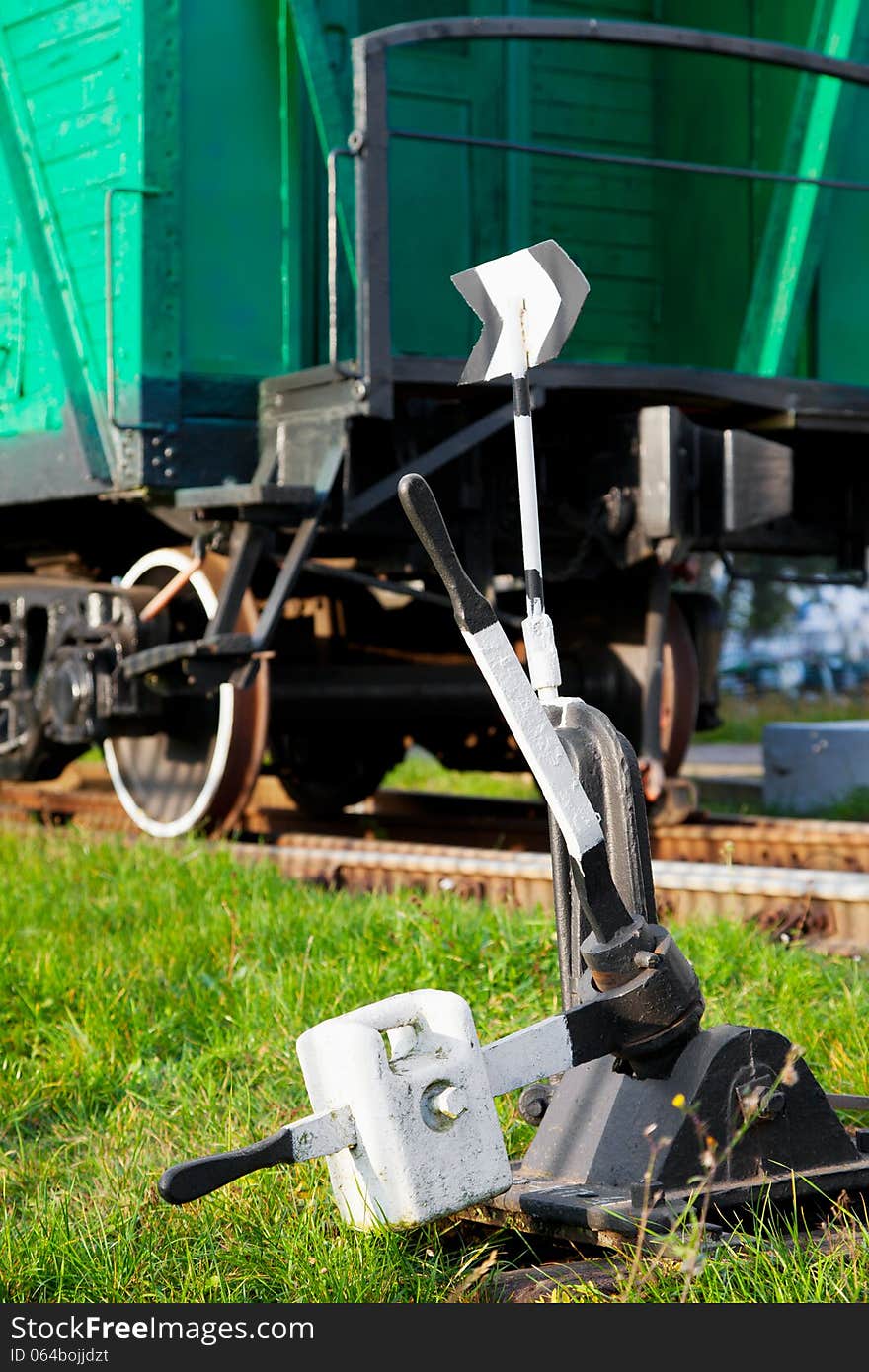 Old railway switch and retro train wagon. Old railway switch and retro train wagon