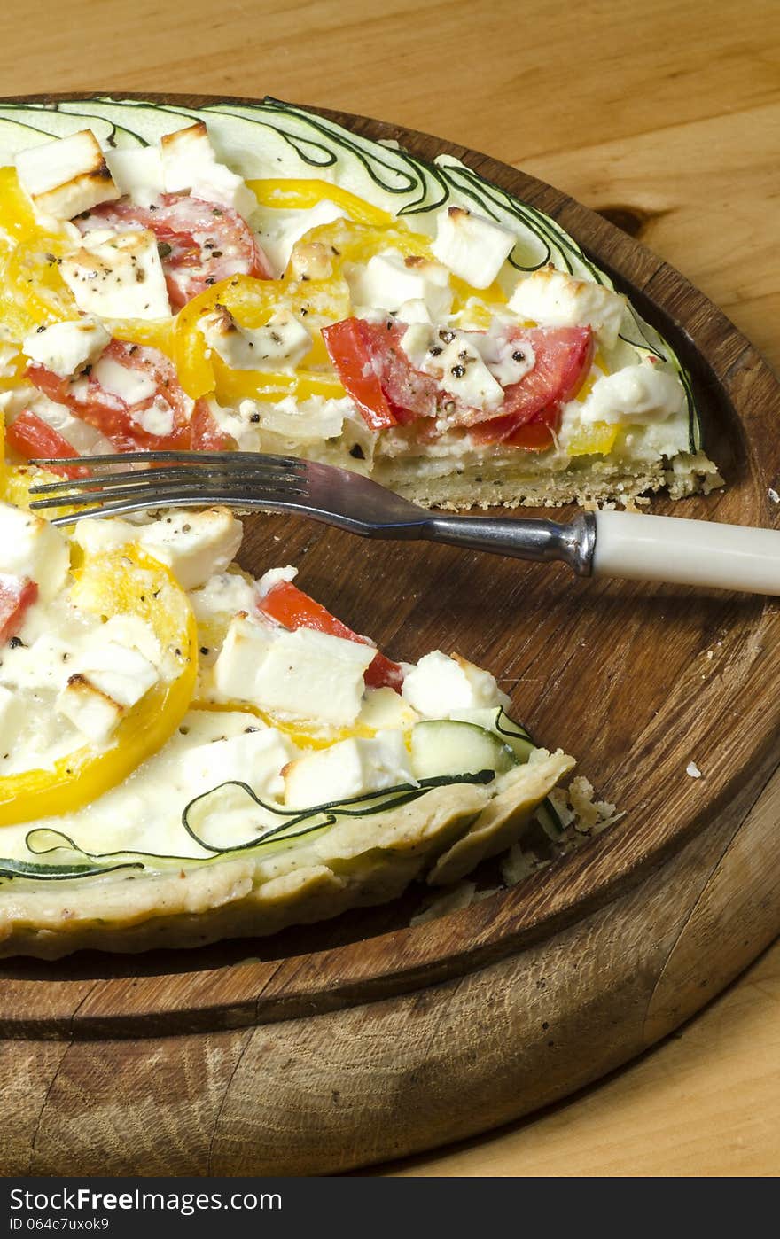 Ready vegetable pie on wooden cutting board. From series Cooking vegetable pie