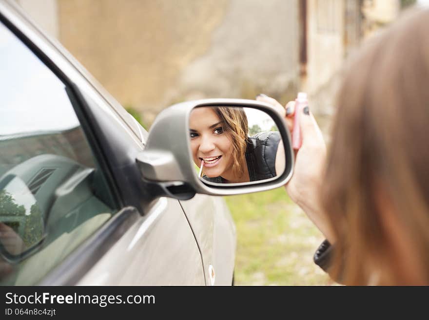 rearview mirror-beautiful girl make-up