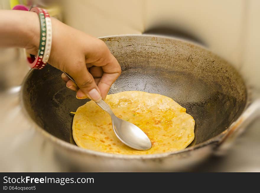 Frying karai or pan prantha indian breakfast in refined oil. Frying karai or pan prantha indian breakfast in refined oil