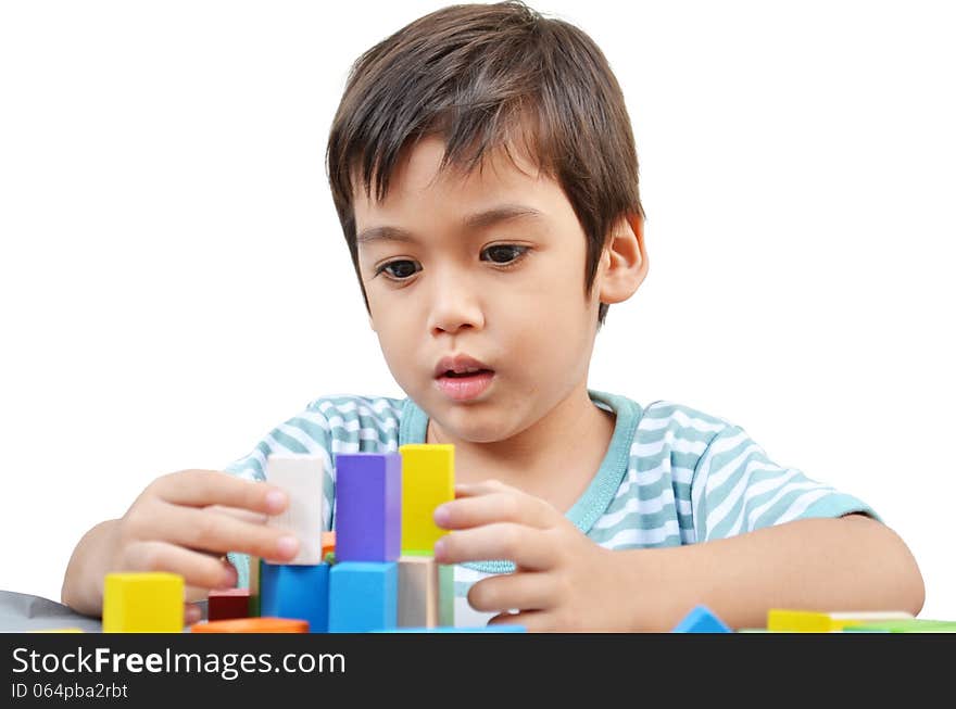 Little boy play block on white background