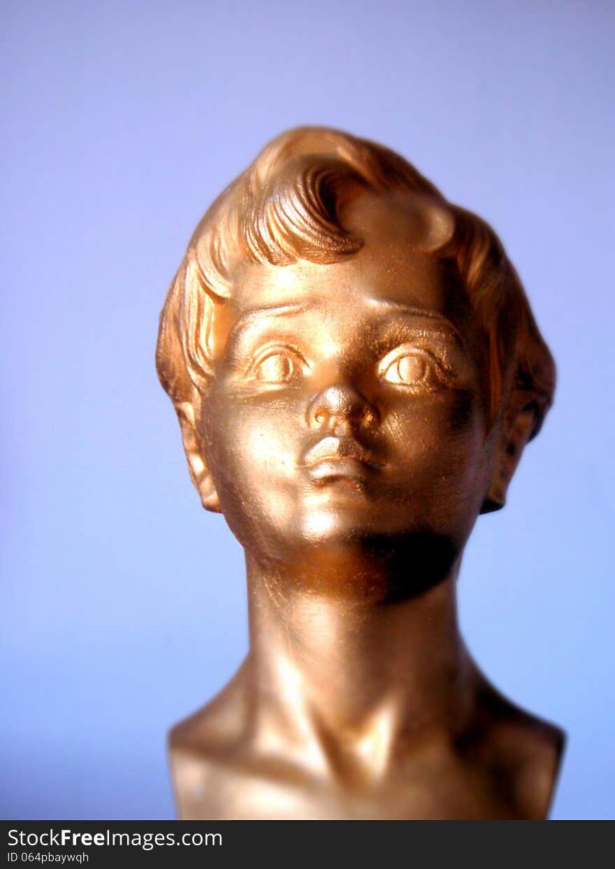 Head figure golden boy with blue background