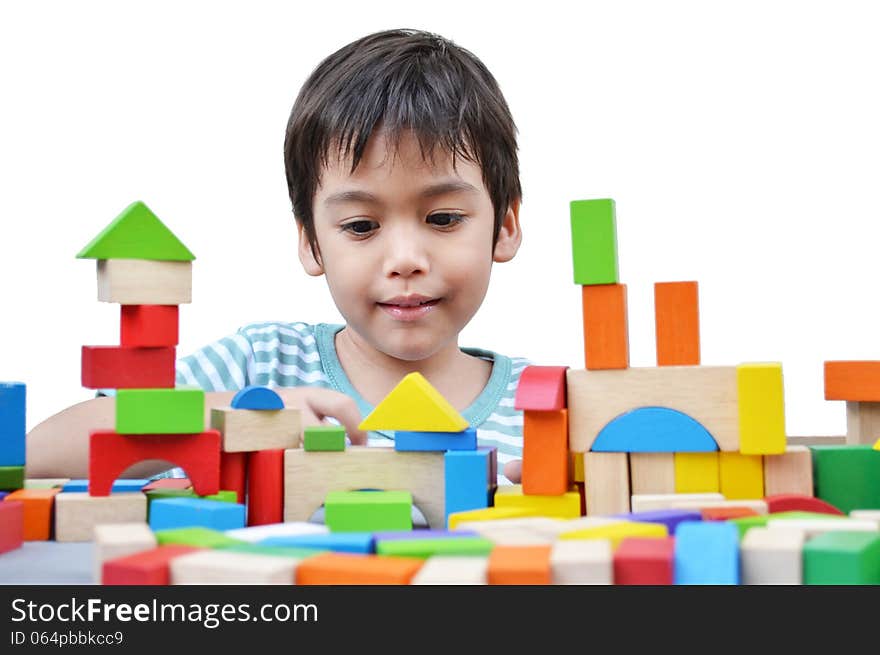 Little boy play block on white background