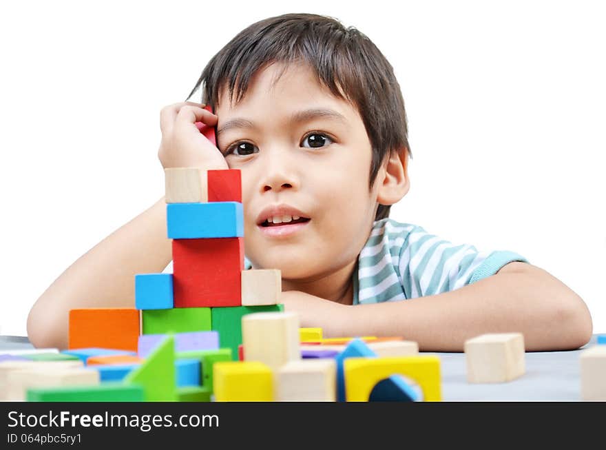 Little boy play block on white background