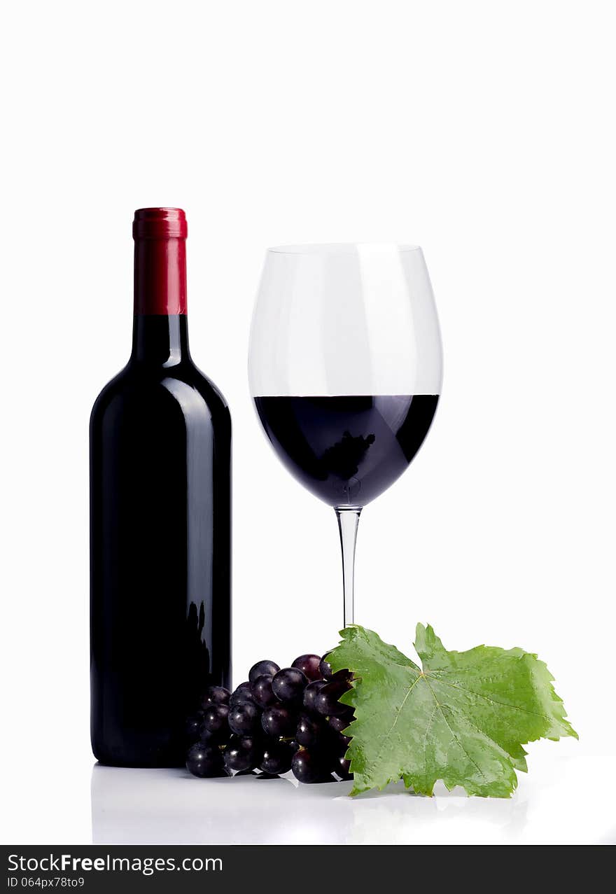 Bottle of wine with glass and grapes on white desk over white background. Bottle of wine with glass and grapes on white desk over white background.