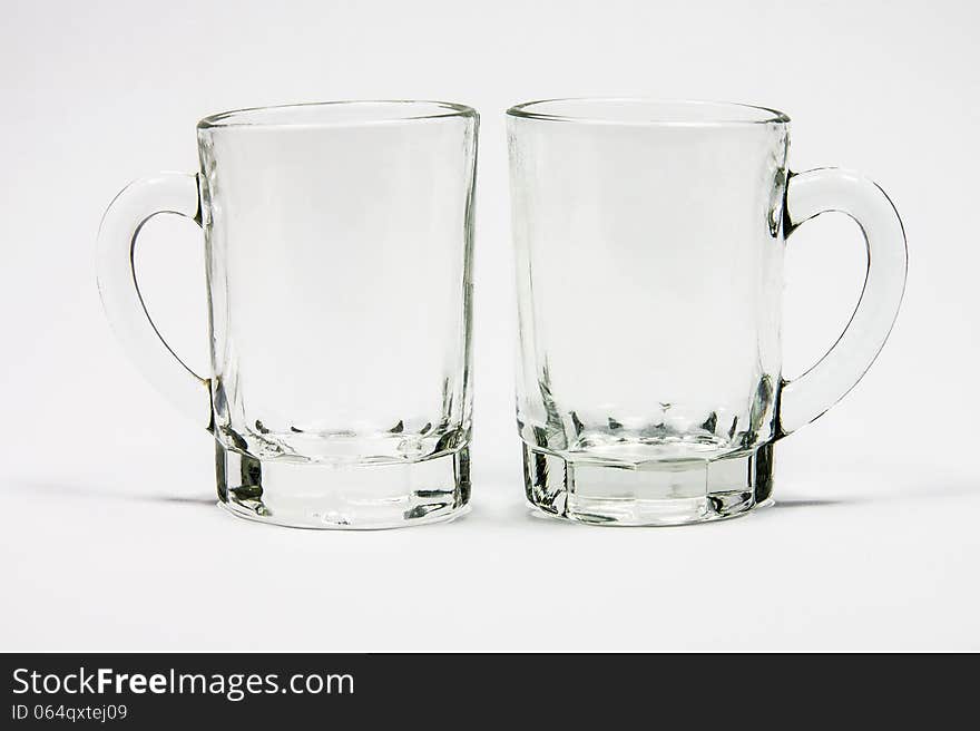 Two glass cups with handle isolated on white background