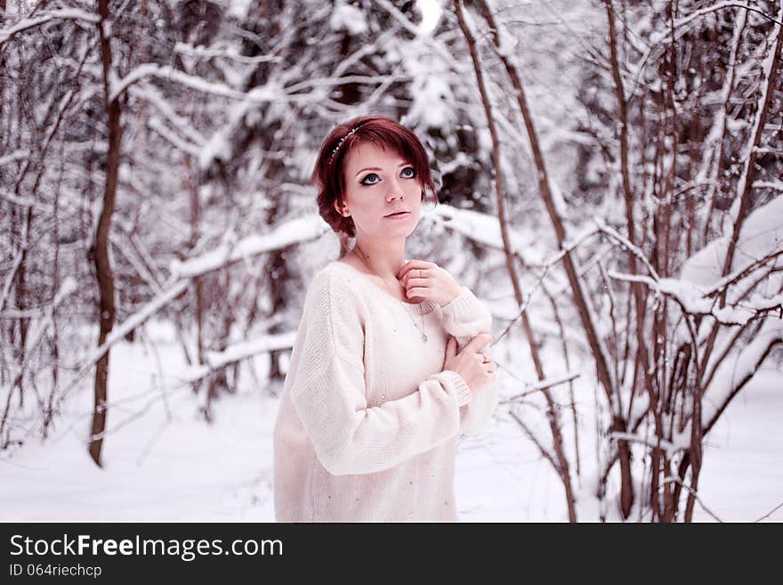 Dreaming girl standing in snow forest. Dreaming girl standing in snow forest