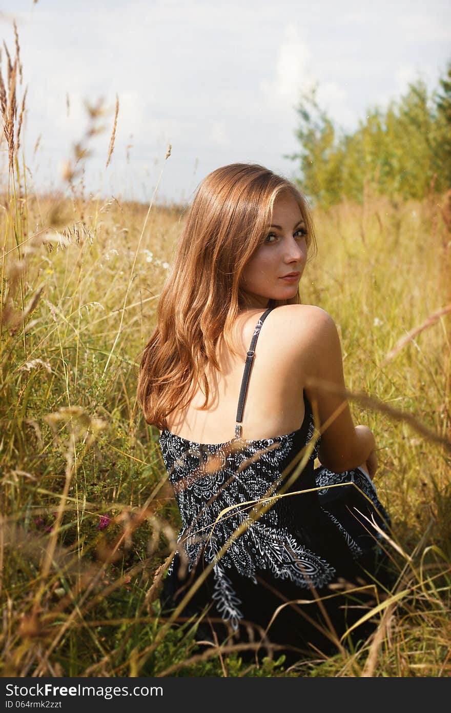 Girl sitting in cornfield