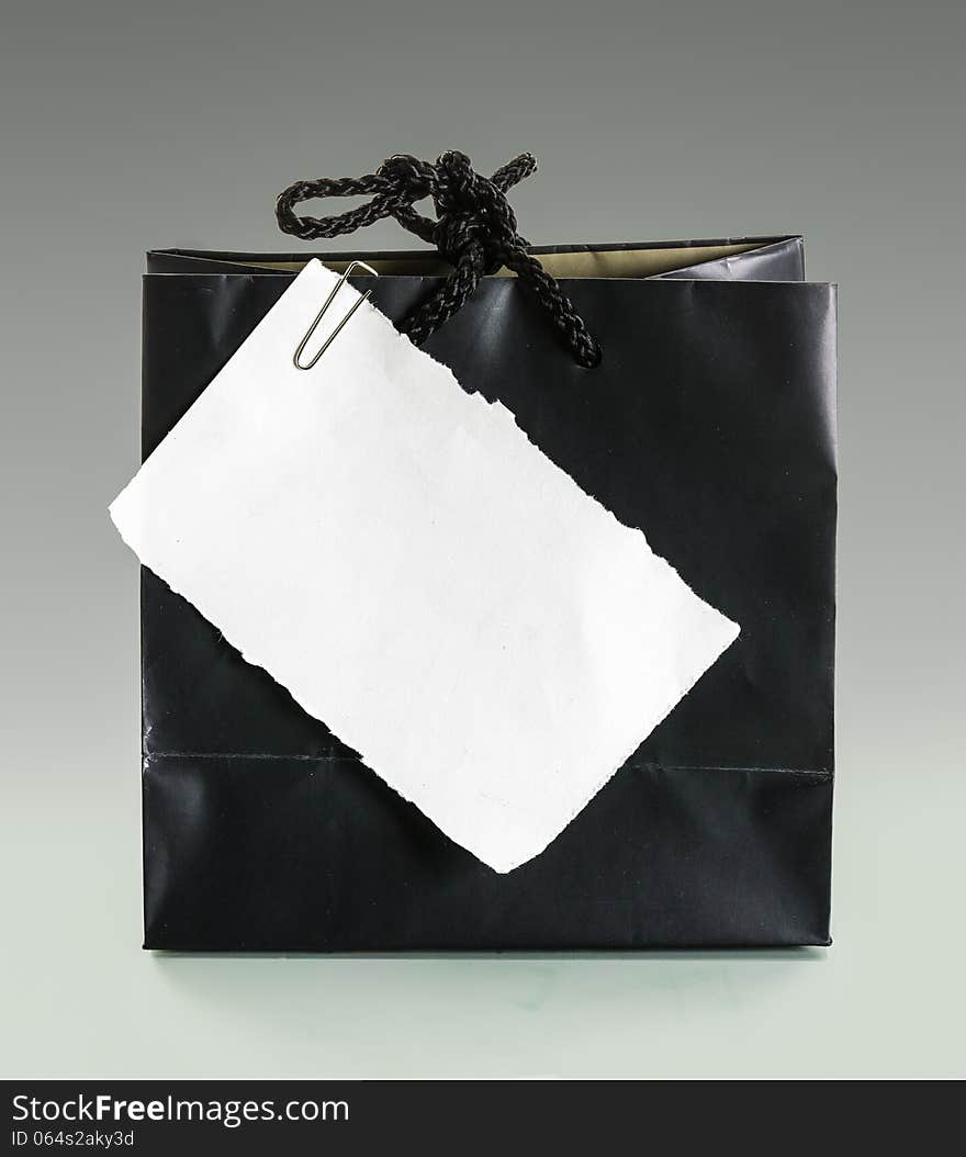 Blank note paper and paper-clip on the black old paper bag. Blank note paper and paper-clip on the black old paper bag
