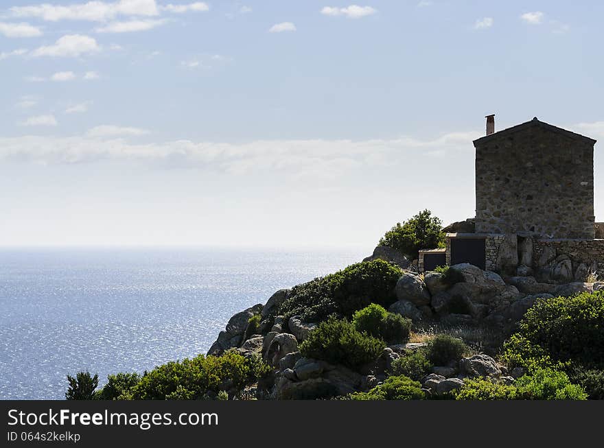 Stone house overlooking the sea. Blue sky with strong contrast.