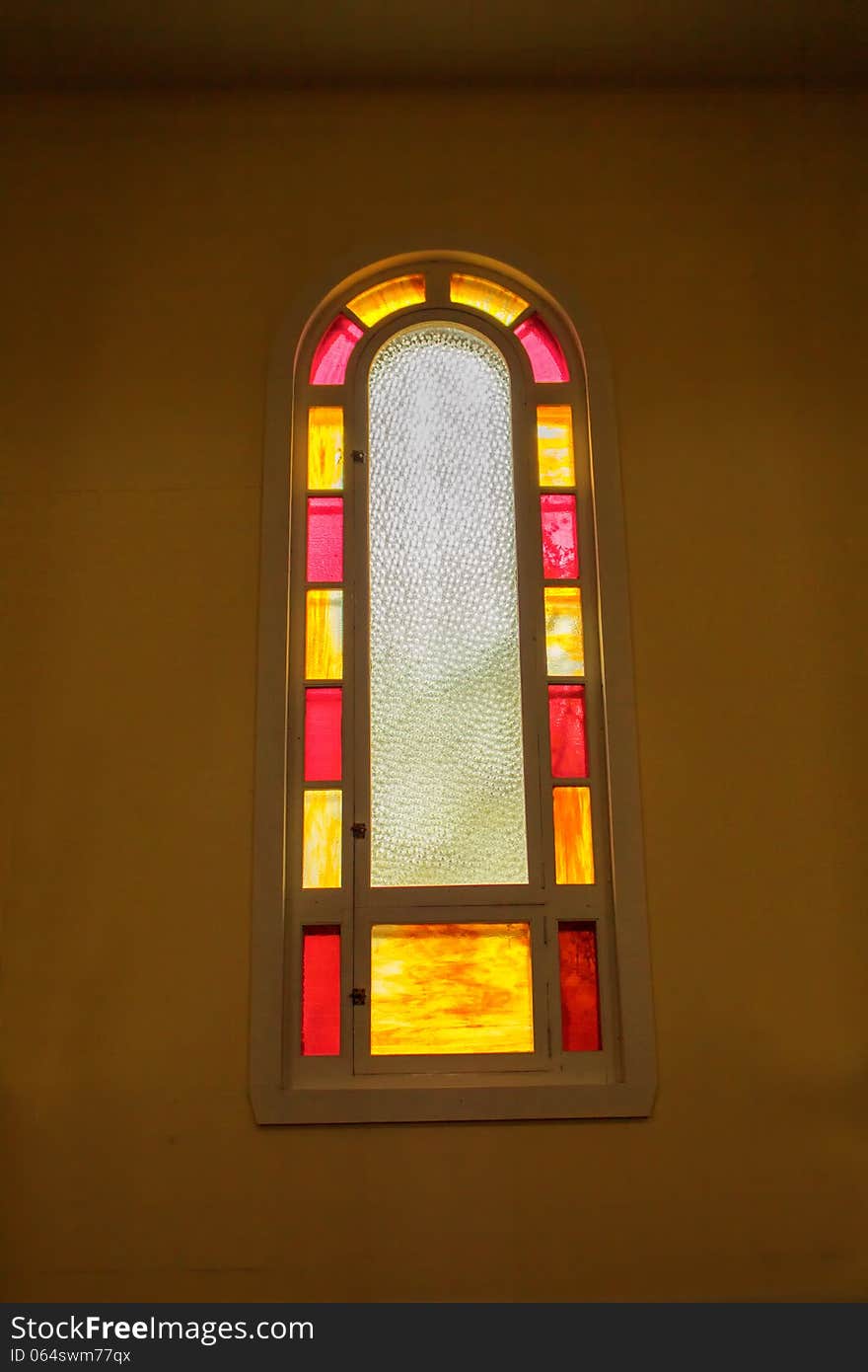 A long painted church window arched at the top