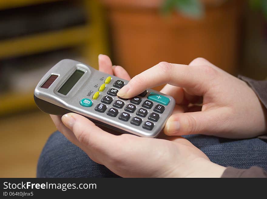 Woman's hands with a calculator. Horizontally. Woman's hands with a calculator. Horizontally.