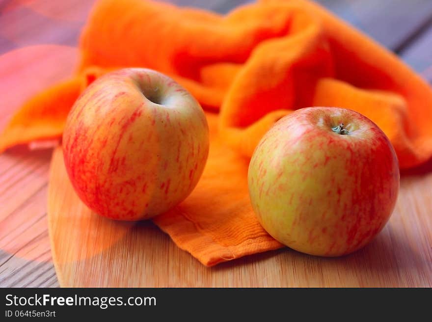 Red apples on wooden kitchen table