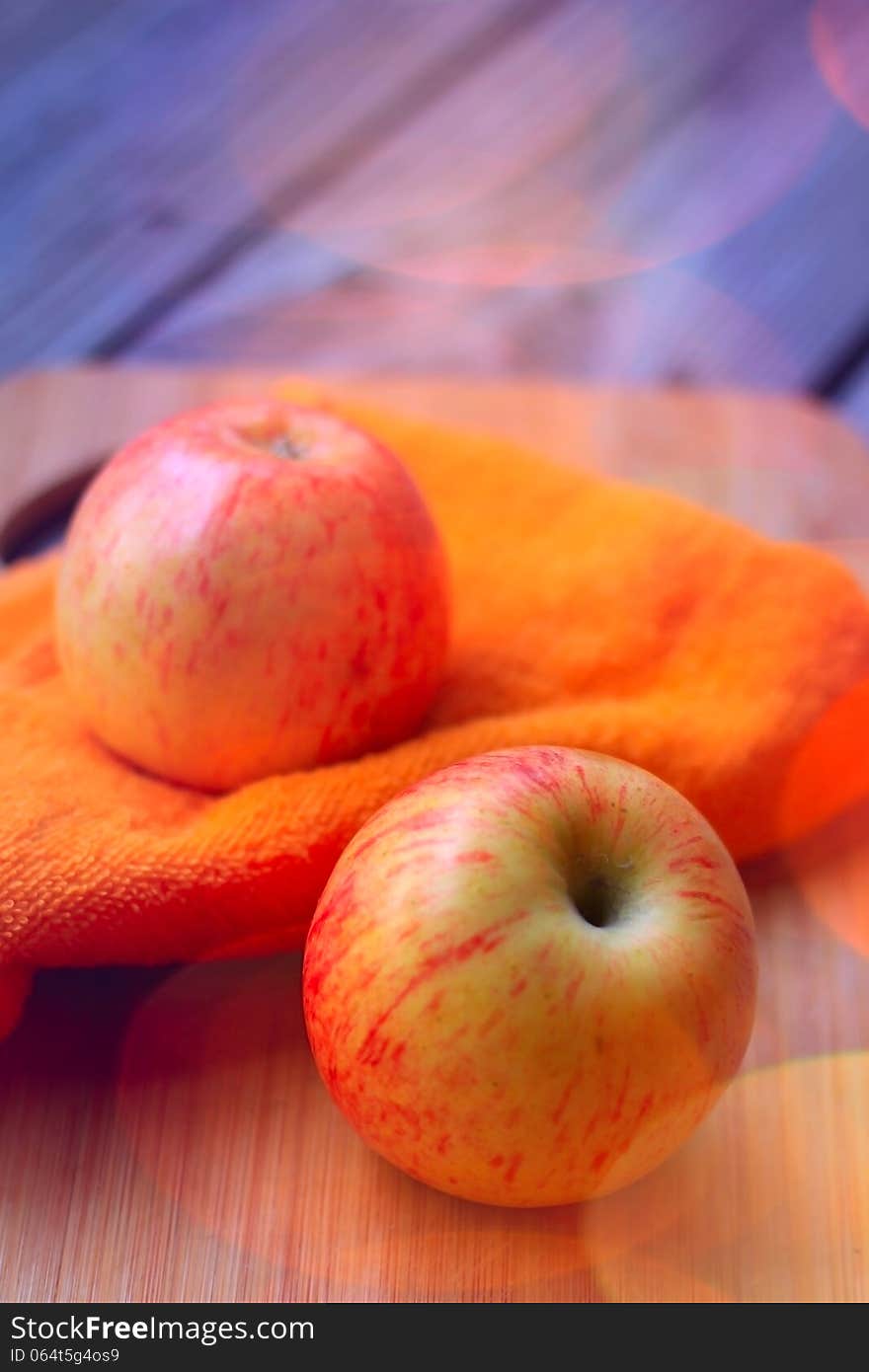 Red apples on wooden kitchen table