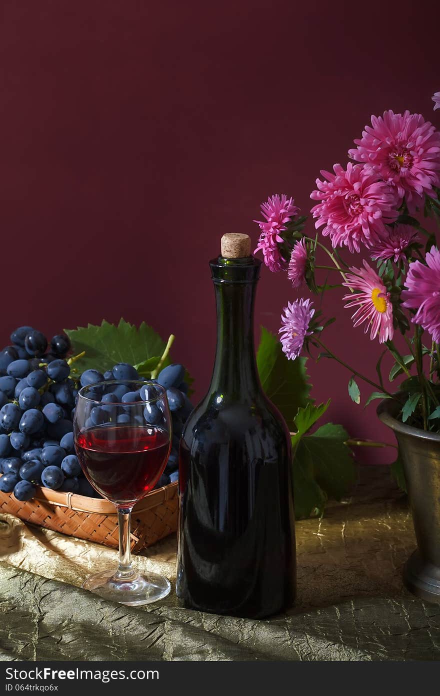 Still-life with bouquet of autumn flowers and dark grapes. Still-life with bouquet of autumn flowers and dark grapes