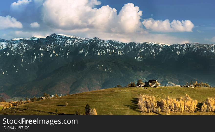 Landscape with big mountains in background and a village in the morning. Landscape with big mountains in background and a village in the morning