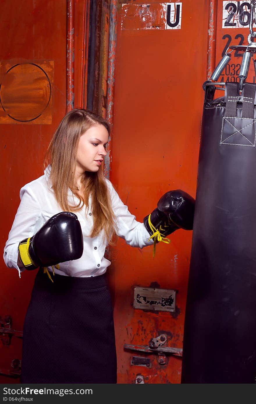 Angry businesswoman with boxing gloves