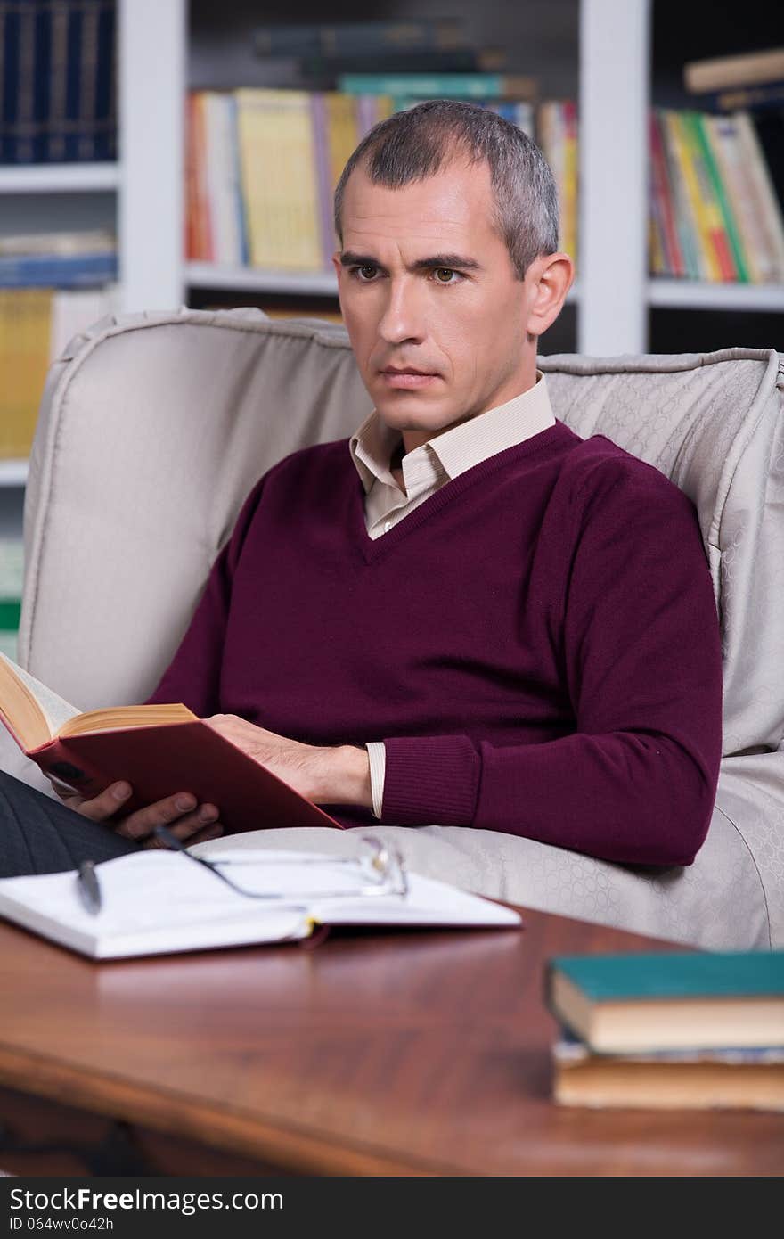 Handsome successful lawyer reading a book. Handsome successful lawyer reading a book