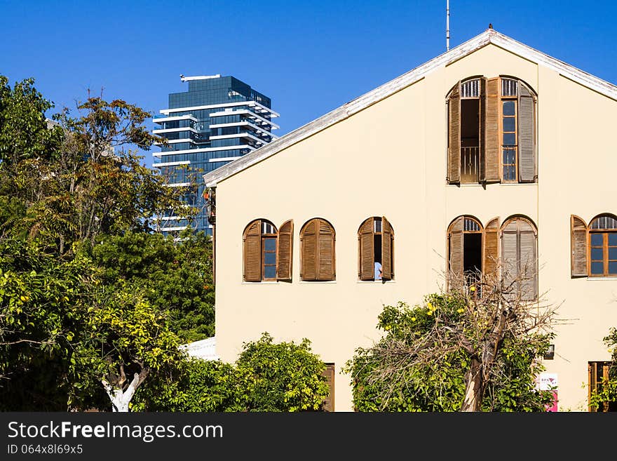 Beautiful old house on a background of a skyscraper