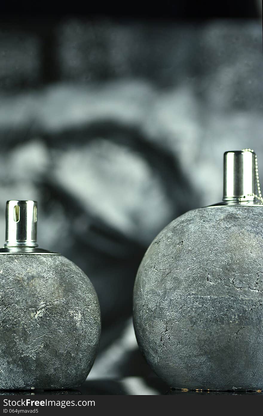 Two oil lamps that burn with a lovely flame, in the background a picture of a Buddha