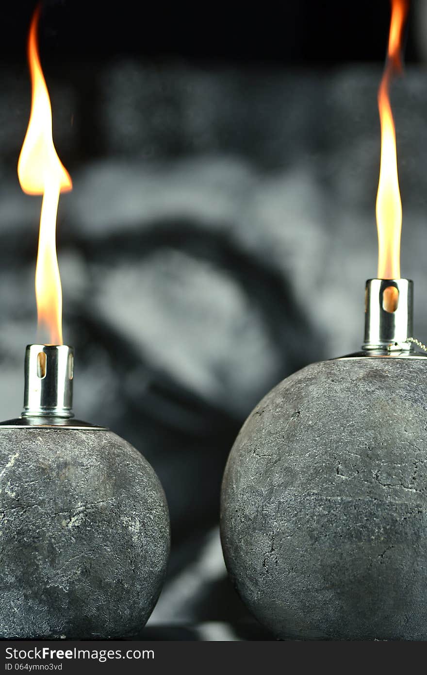 Two oil lamps that burn with a lovely flame, in the background a picture of a Buddha. Two oil lamps that burn with a lovely flame, in the background a picture of a Buddha