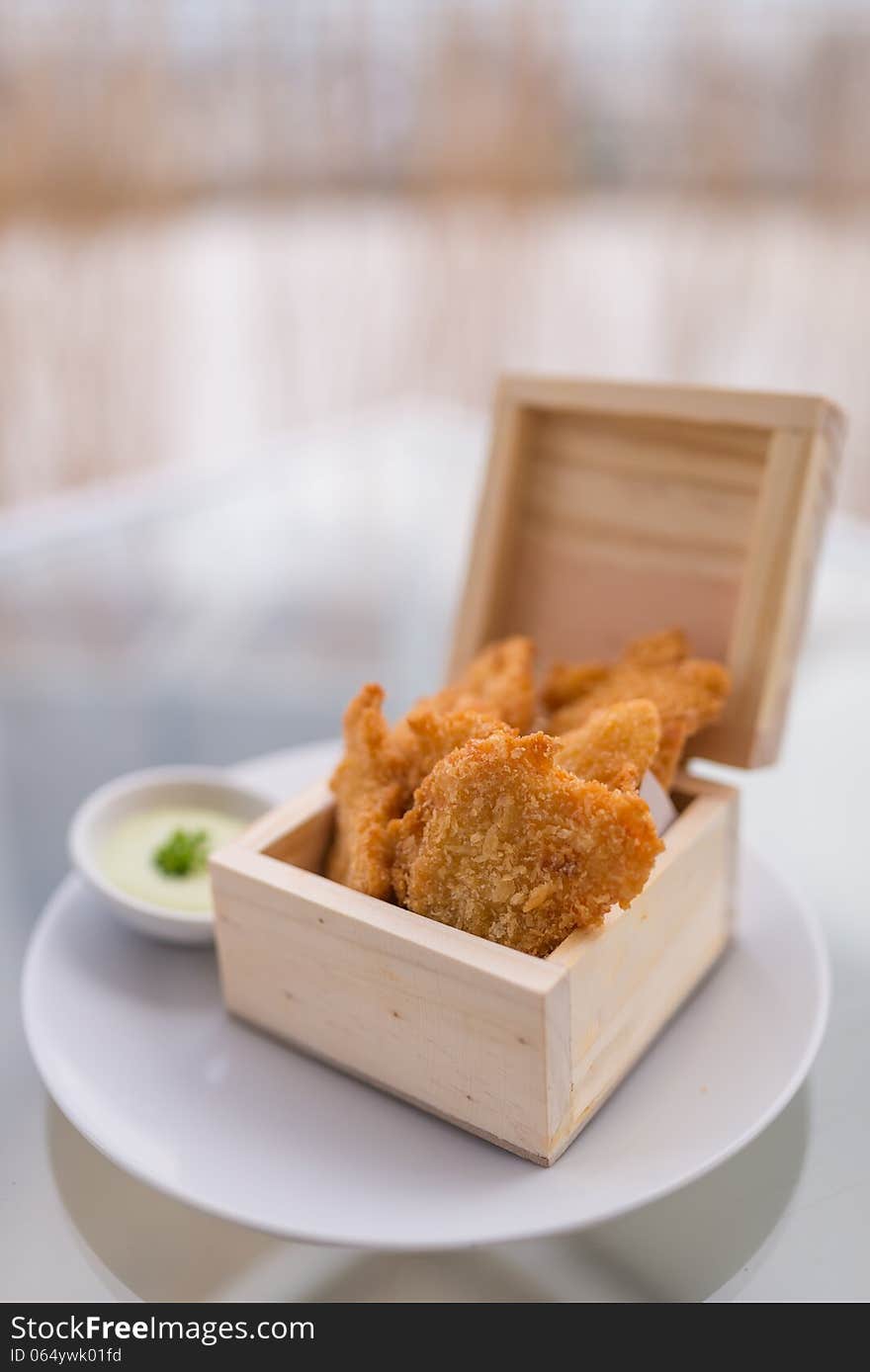 Crisp fish finger nugget in wooden box