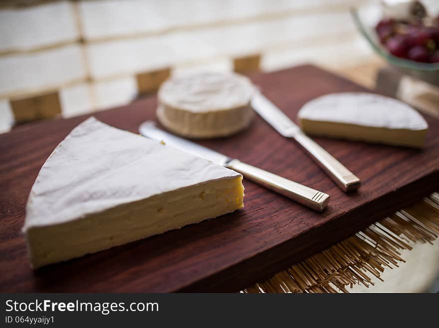 Variety of cheese on wooden board buffet line