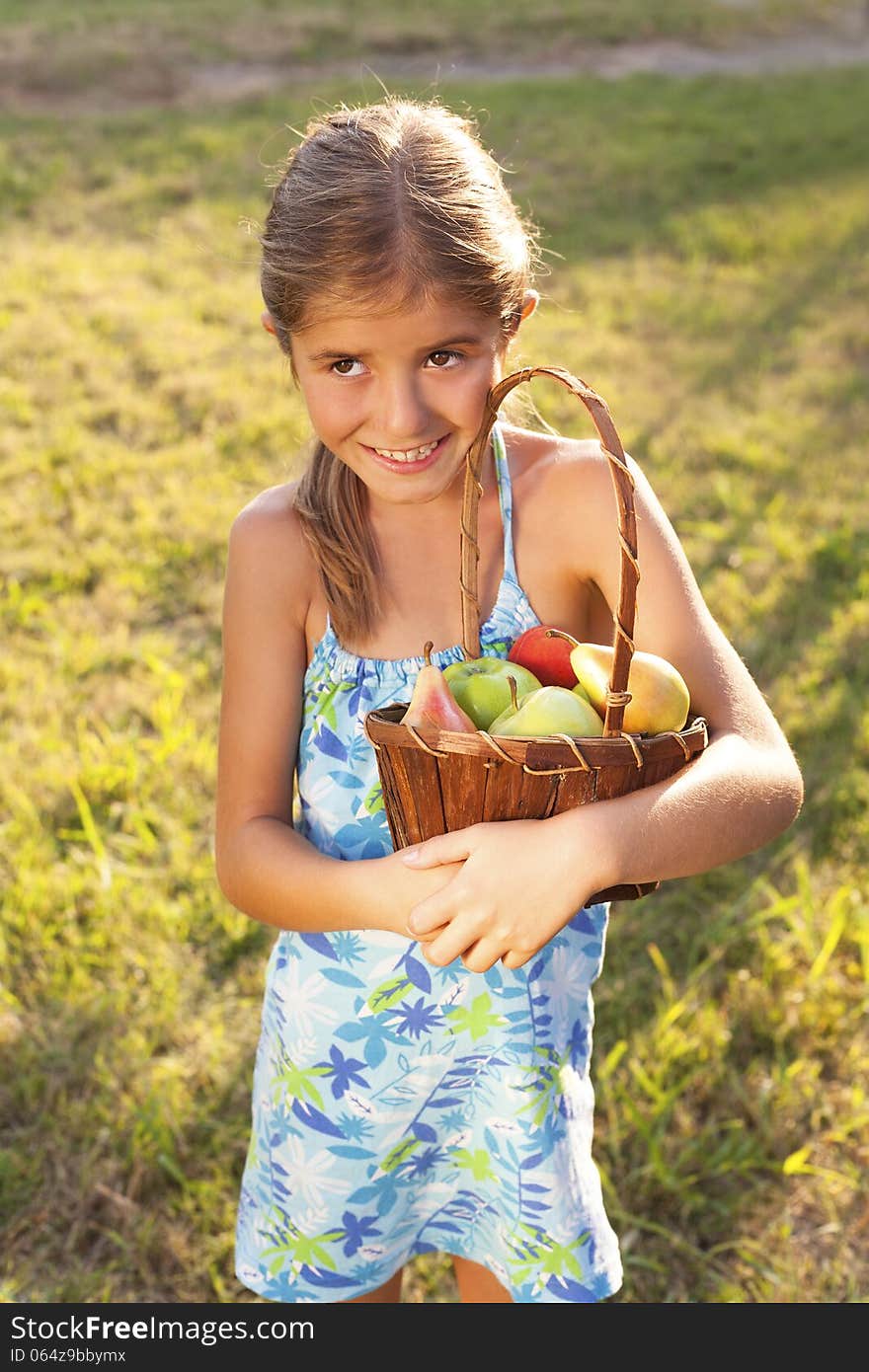 Little Girl With Basket Of Fresh Fruit