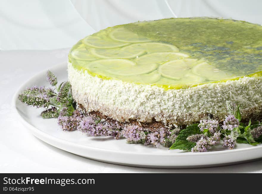 Lime cheesecake decorated with mint flowers