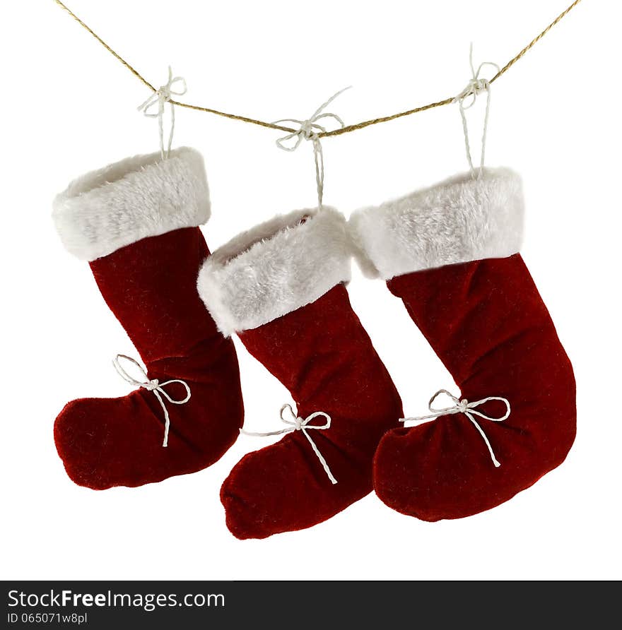 Three red Santa boots on string isolated on white. Three red Santa boots on string isolated on white