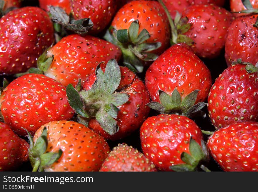 For background or design element, strawberry over blackbackground. For background or design element, strawberry over blackbackground