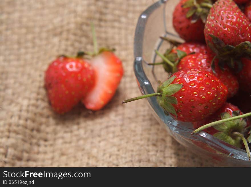 A bowl of strawberry, at natural sack cloth