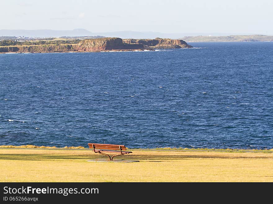 A beautiful beach view and park with a chair where you can see mountains. A beautiful beach view and park with a chair where you can see mountains.