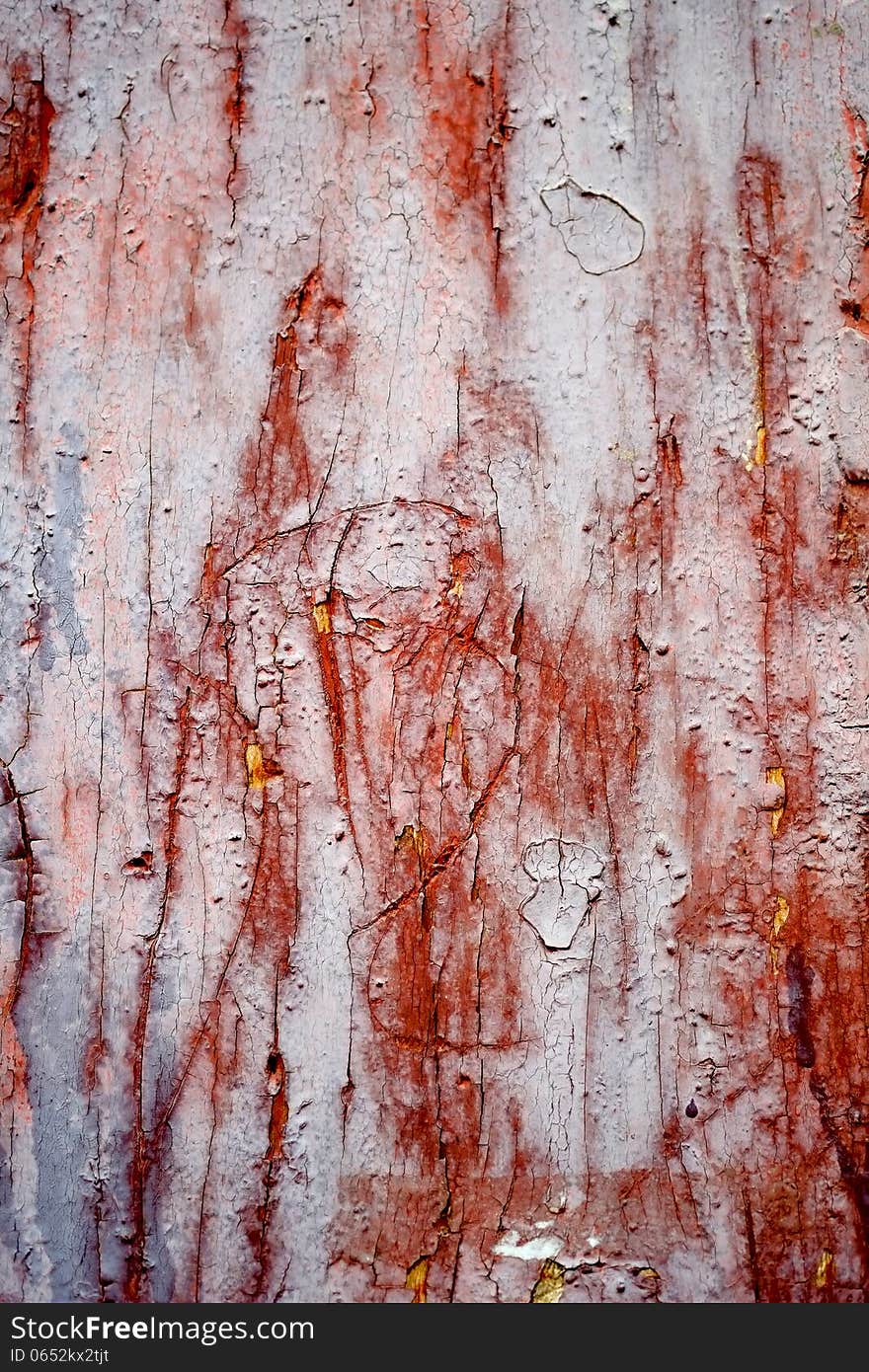 Wood texture creating a nice abstract surface with old red scratched paint