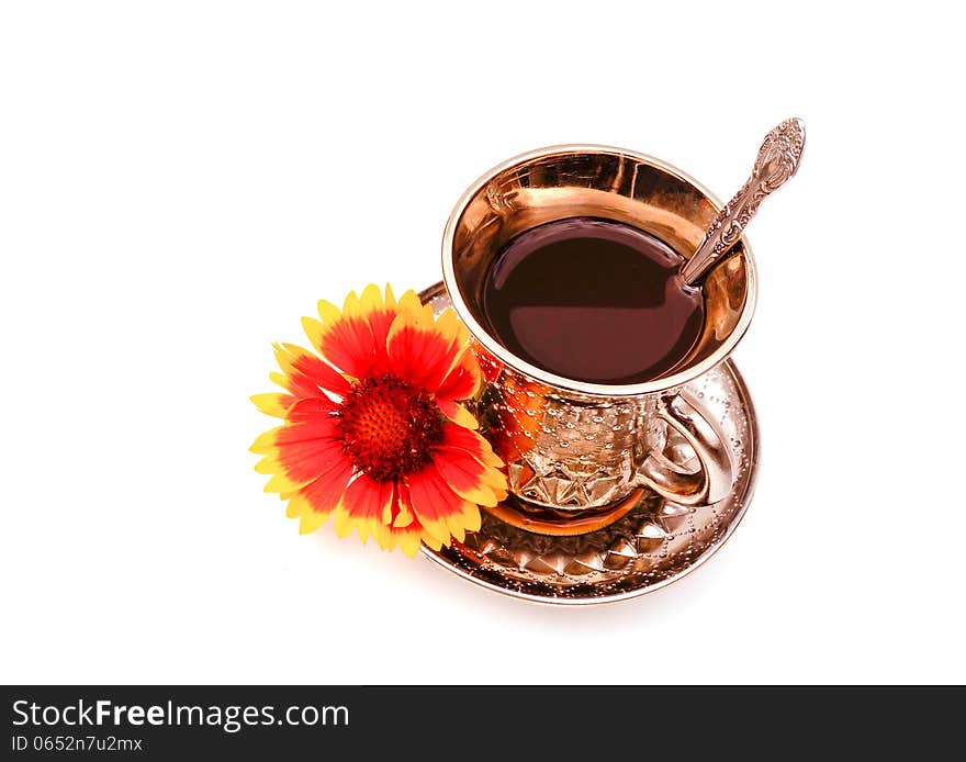 Cup of coffee on a saucer with a flower on white. Cup of coffee on a saucer with a flower on white