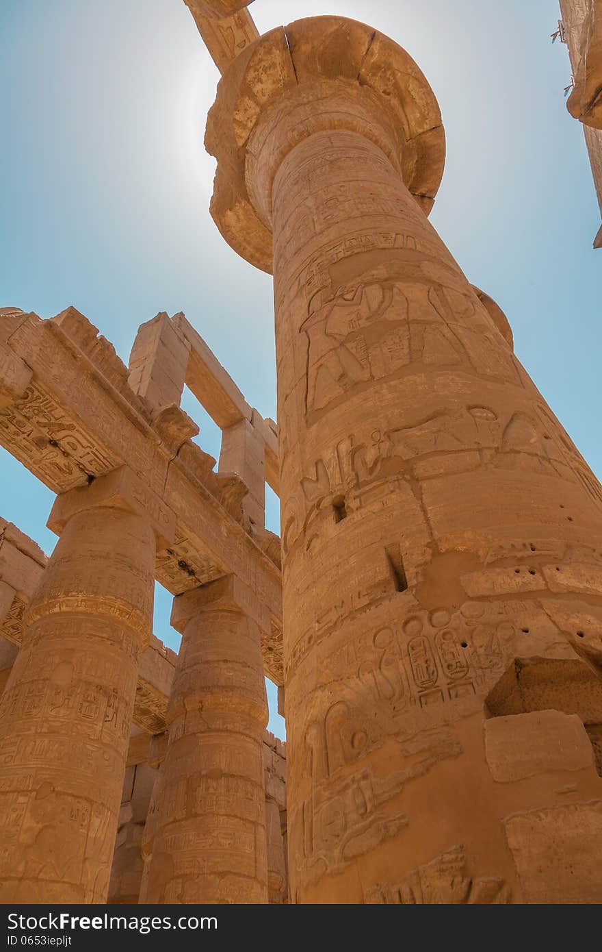 Huge columns in the Karnak Temple. Ancient Egyptian hieroglyphs on columns. Huge columns in the Karnak Temple. Ancient Egyptian hieroglyphs on columns