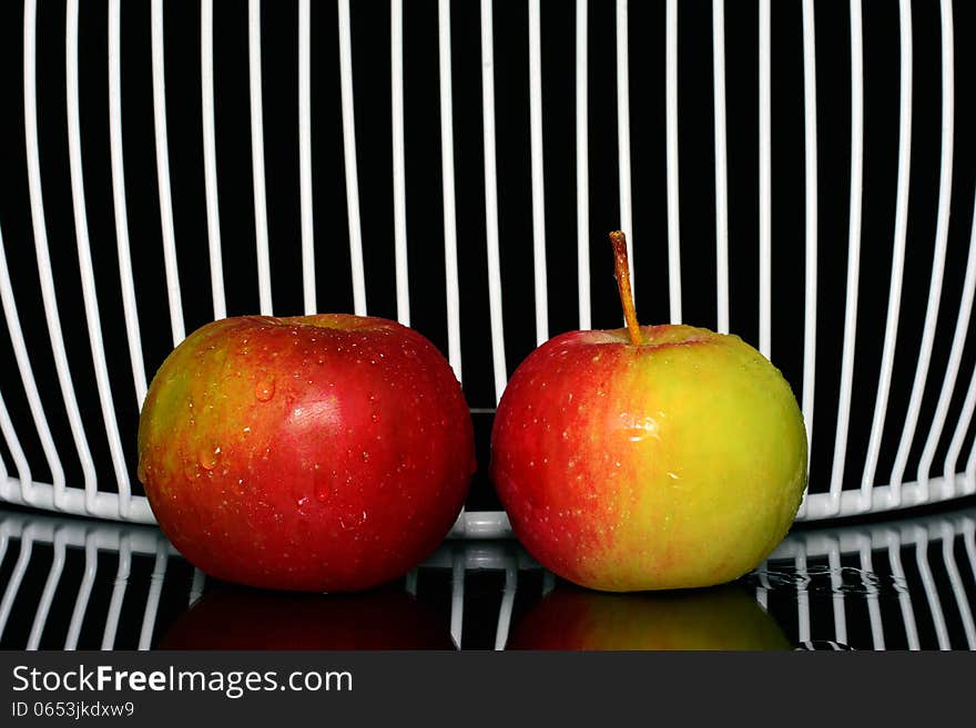 Three apples on a line, with net in background. Three apples on a line, with net in background