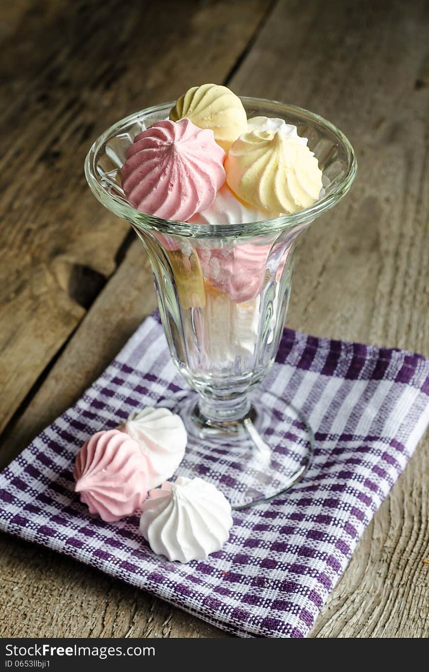 Glass bowl with colorful meringue cookies