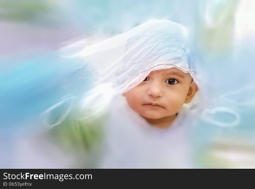 Happy infant baby boy portrait playing with cloth with zoom blur effects. Happy infant baby boy portrait playing with cloth with zoom blur effects