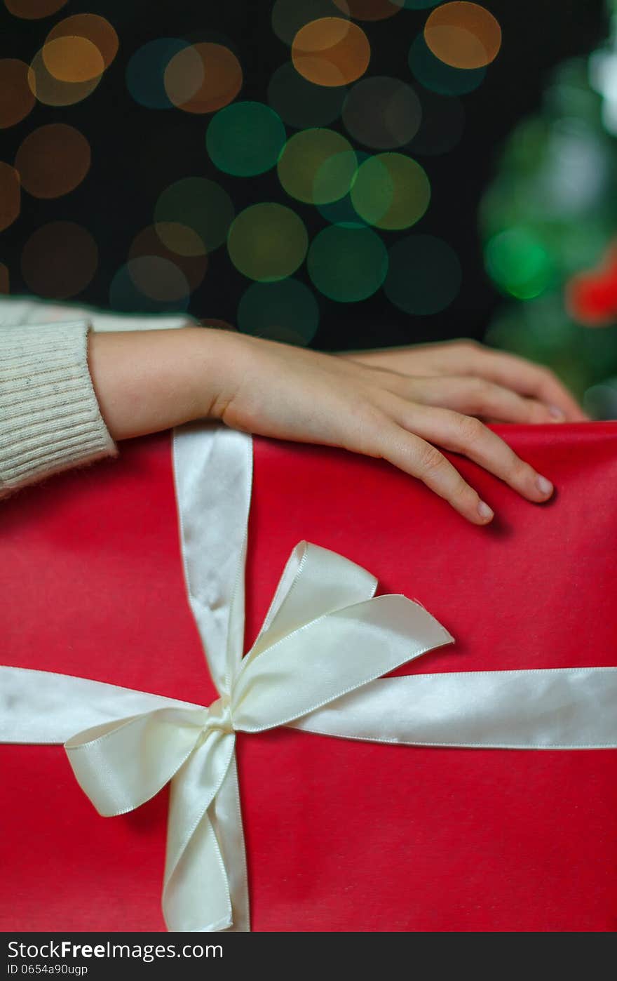 Child hands holding christmas gift. Child hands holding christmas gift