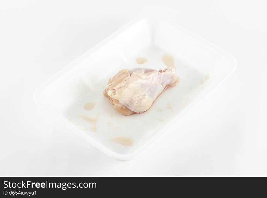 Food fresh chicken in foam isolated on white background. Food fresh chicken in foam isolated on white background