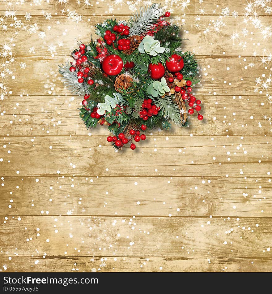 Christmas wreath with apples and red berries on a vintage wooden