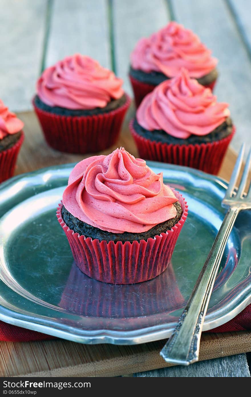 Chocolate cupcakes with cherry frosting. Chocolate cupcakes with cherry frosting.