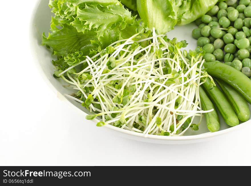 Green vegetable on white dish isolated on white background