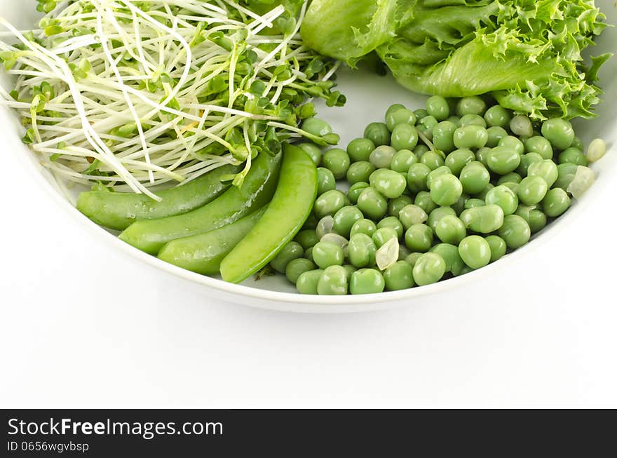 Green vegetable on white dish isolated on white background