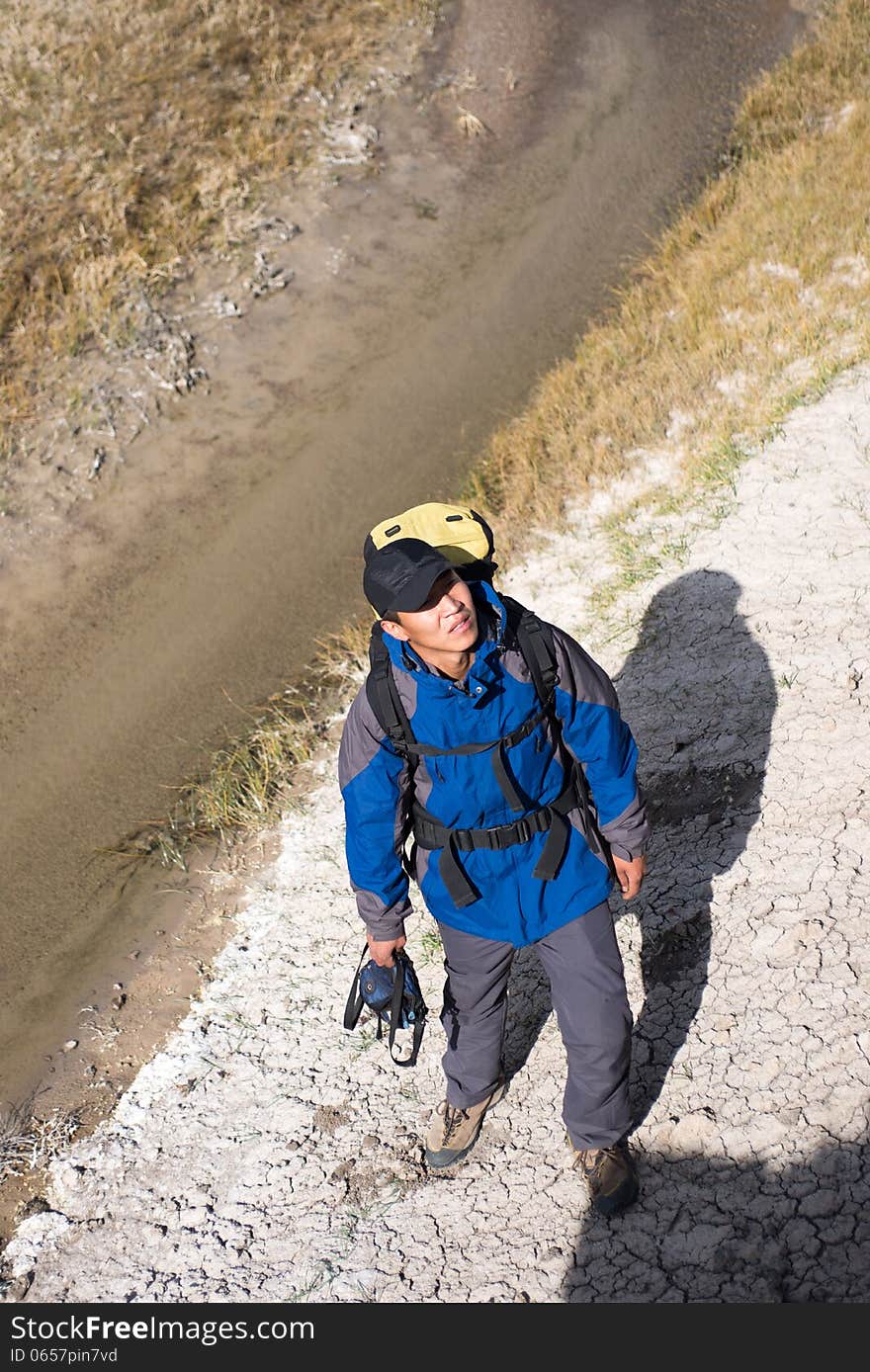 Hiker standing on the river side. high angle shot. Hiker standing on the river side. high angle shot