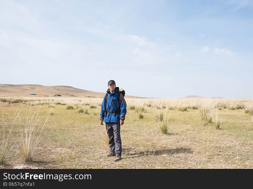 Hikers walking in the autumn meadow. Asian Youth. Hikers walking in the autumn meadow. Asian Youth