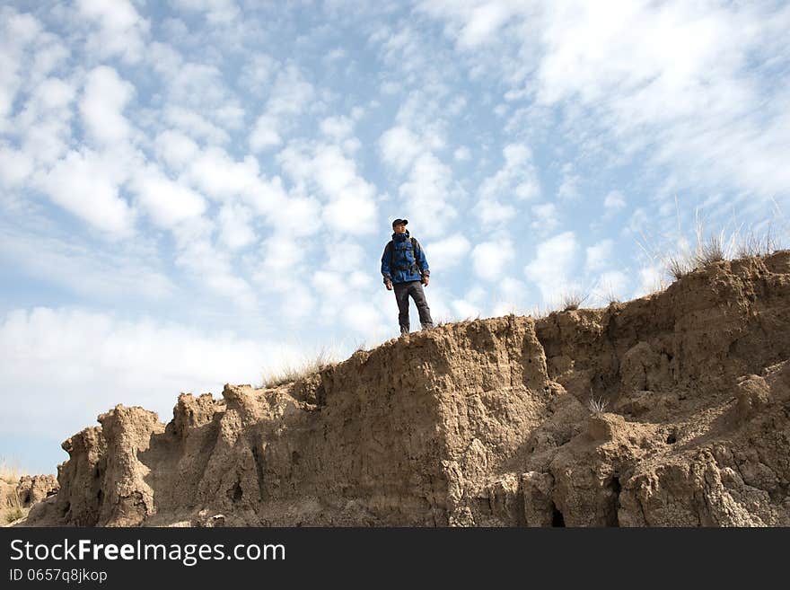 Hiker standing on a cliff overlooking. Asian Youth. Hiker standing on a cliff overlooking. Asian Youth