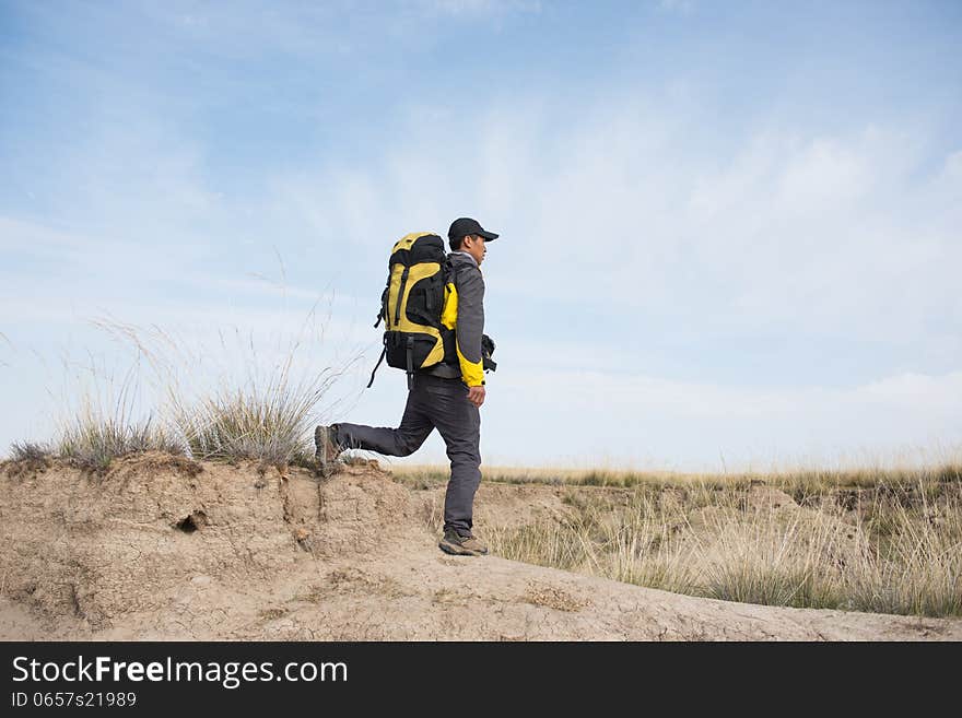 Hikers walking in autumn steep hill. Asian Youth. Hikers walking in autumn steep hill. Asian Youth