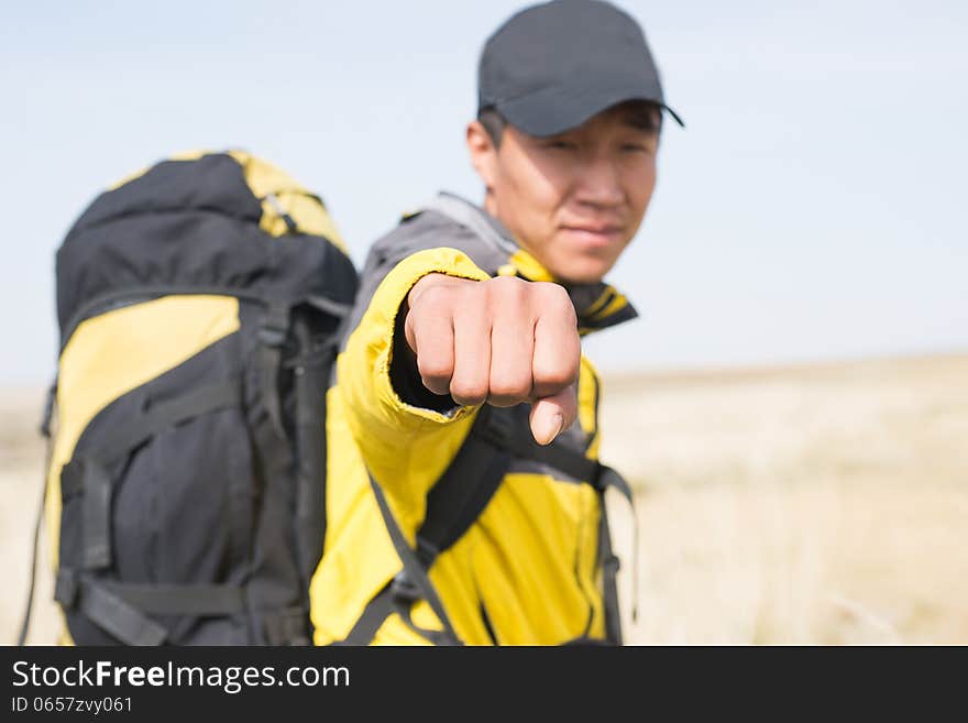 Hikers fist closeup blur background figure. Asian Youth